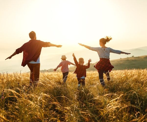 Happy family: mother, father, children son and  daughter on nature  on sunset