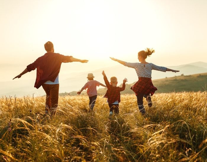 Happy family: mother, father, children son and  daughter on nature  on sunset